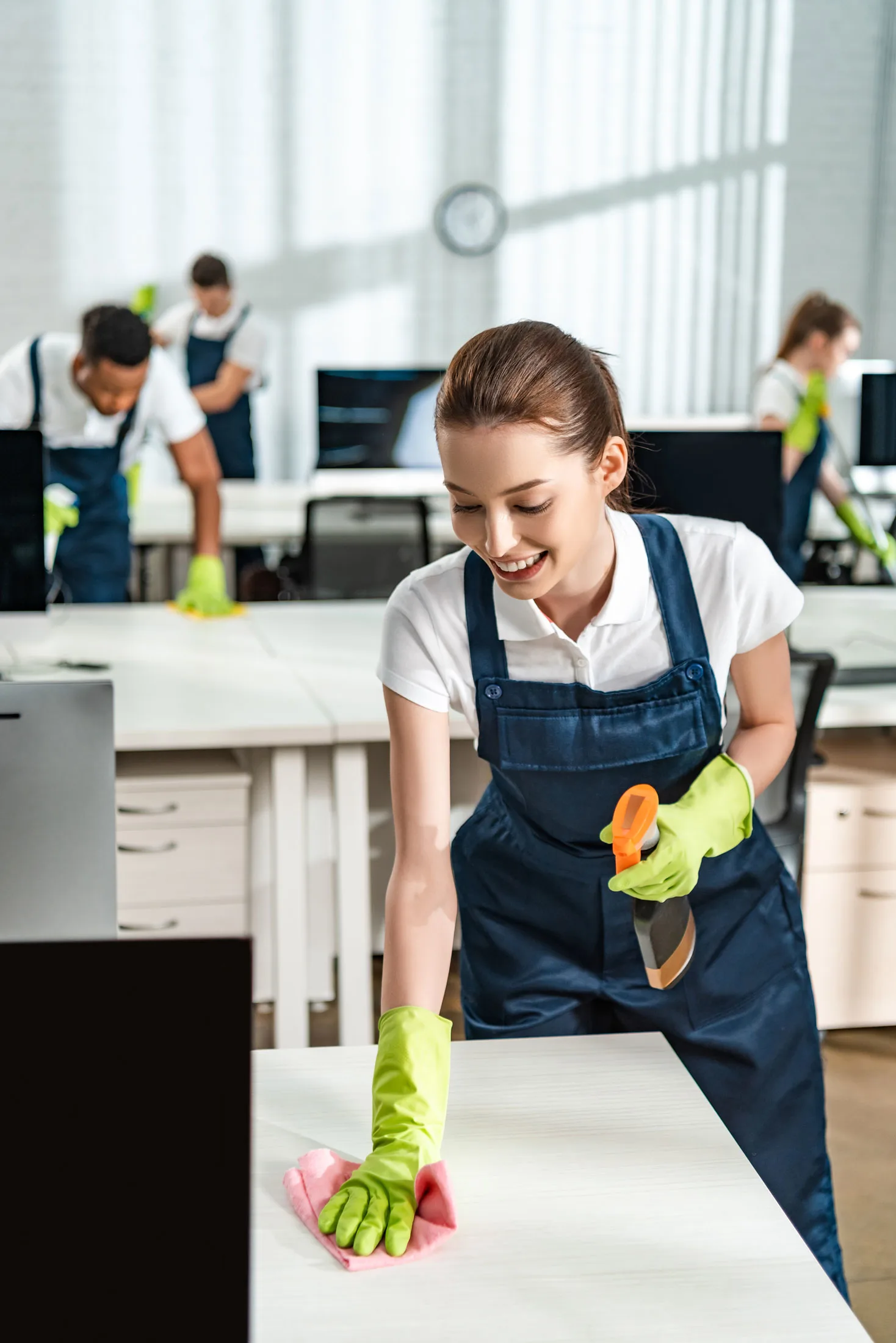 Black Mountain Cleaners staff cleaning desks in an office in Spearfish.